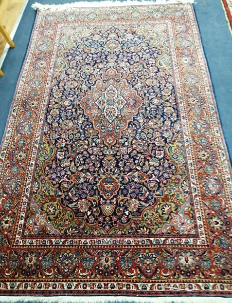 A Kashan red ground rug 212 x 130cm